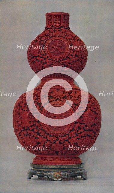 'Vase of Carved Red Lacquer on Olive Green Ground with Stand of Flat Lacquer', 1928. Artist: Unknown.