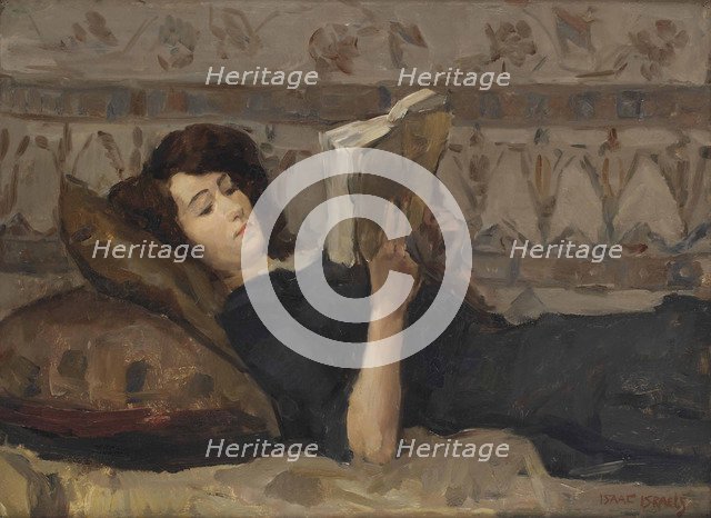 Girl reading on a sofa, c. 1920.