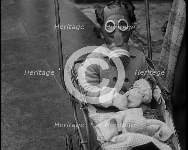 A Young Child in a Pram Wearing a Gas Mask, 1939. Creator: British Pathe Ltd.