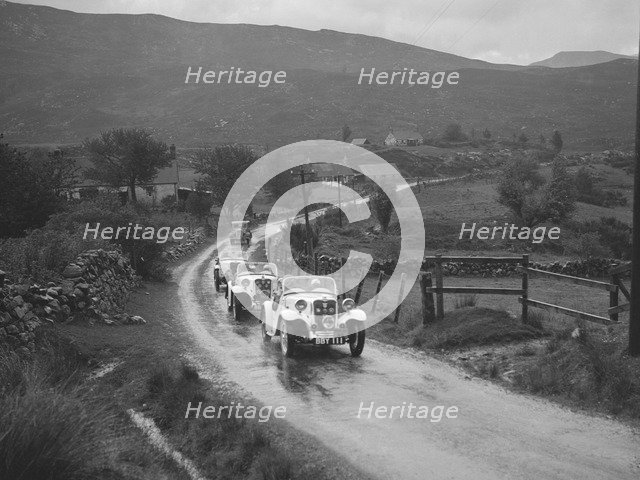 Two Singer Le Mans cars competing in the RSAC Scottish Rally, 1936. Artist: Bill Brunell.