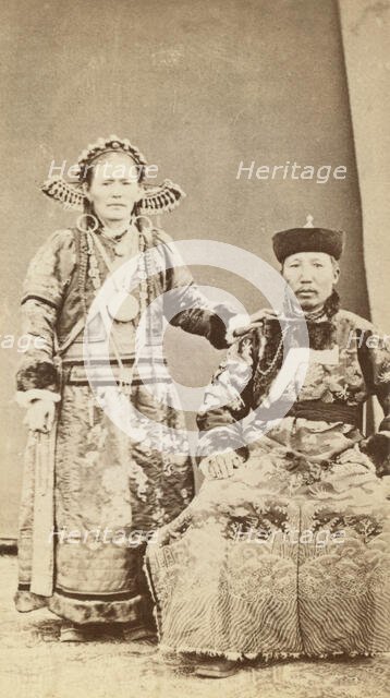 Full-length portrait of wealthy Buriat man and his wife, facing front, between 1870 and 1886. Creator: Unknown.