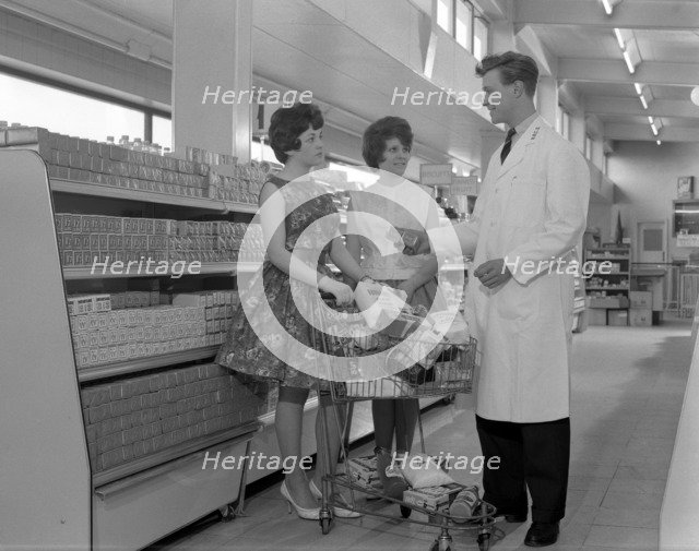 Supermarket shoppers and salesman, Co-op, Barnsley, South Yorkshire, 1961. Artist: Michael Walters