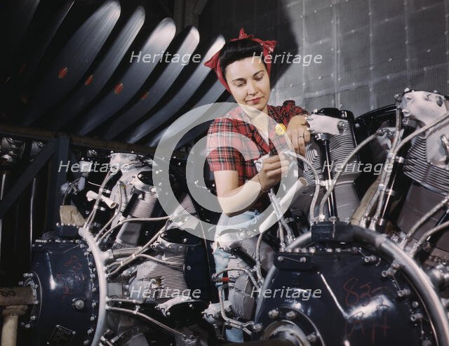 Woman working on an airplane motor at North American Aviation, Inc., plant in Calif., 1942. Creator: Alfred T Palmer.