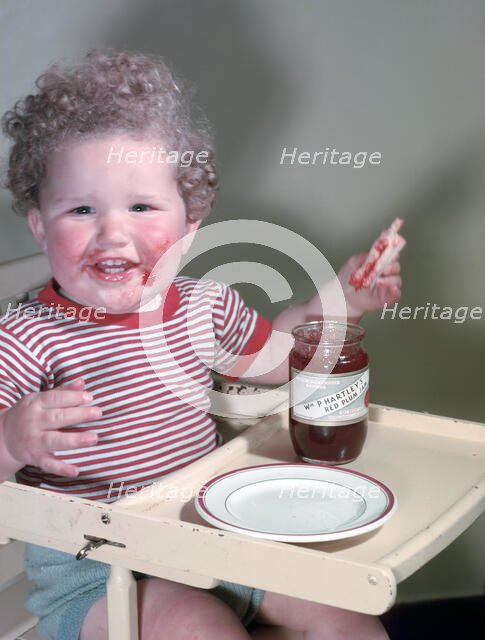 Young child eating P Hartley's Red Plum Jam and bread, c1955.  Creator: Arthur Charles Kirby Ware.
