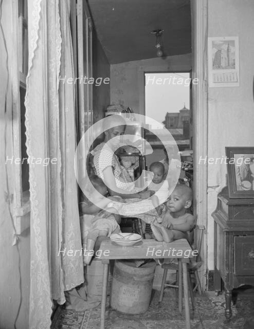 Mrs. Ella Watson, a government charwoman and her grandchildren, Washington, D.C., 1942. Creator: Gordon Parks.