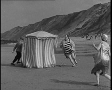 A Male Actor With a Moustache and Bowler Hat Being Chased Around a Changing Tent On a Beach...,1920s Creator: British Pathe Ltd.