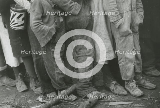 A detailed shot of flood refugees' feet showing their shoes; Forrest City, Arkansas, 1930s. Creators: Farm Security Administration, Walker Evans.