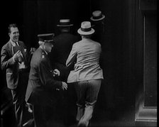 Male Civilians Walking in to a Building, 1929. Creator: British Pathe Ltd.