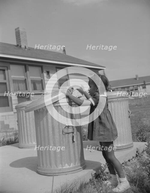Metal ashcans, Frederick Douglass housing project, Anacostia, D.C., 1942. Creator: Gordon Parks.