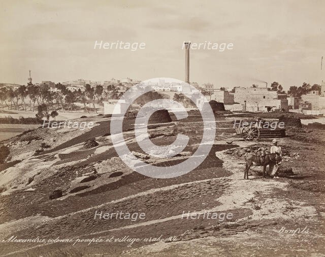Pompey's Pillar and Arab Village at Alexandria, 19th century. Creator: Maison Bonfils.