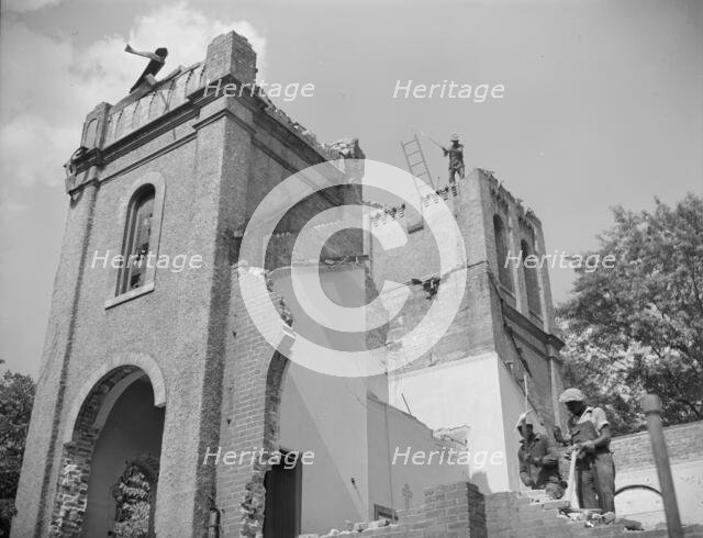 Laborers wrecking buildings on Independence Avenue, Washington, D.C, 1942. Creator: Gordon Parks.