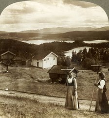 'Country girls in haying time - over Bolkesjo and Folsjo (lakes) to Himingen Mts., Norway', c1905.  Creator: Unknown.