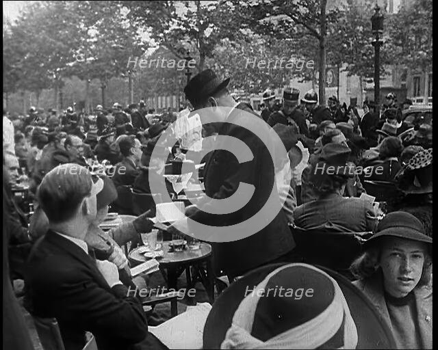 French Police Checking People's Papers Outside a Cafe in Paris, 1940. Creator: British Pathe Ltd.