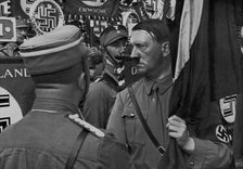 Adolf Hitler dedicating standards at the Nuremberg Rally, Germany, 1935. Artist: Unknown