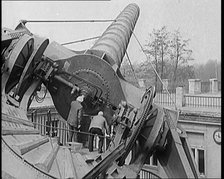 Large Telescope Being Turned by Two Civilians, 1931. Creator: British Pathe Ltd.