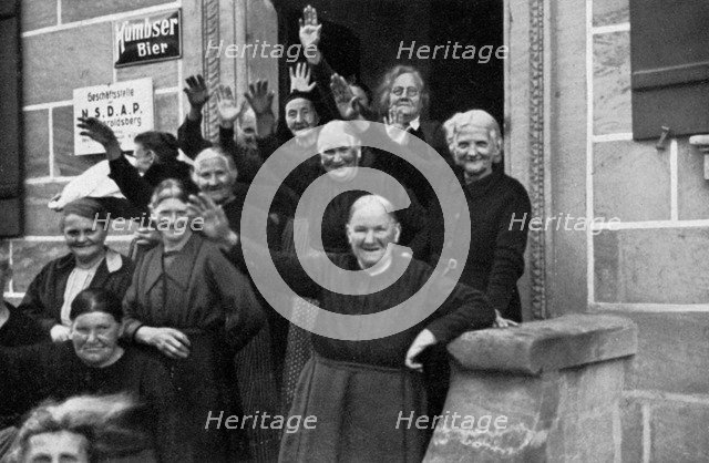 Inhabitants of a small town during a visit by Adolf Hitler, Franconia, Germany, 1936. Artist: Unknown