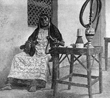 Somali woman smoking a hookah, Aden, 1922. Artist: Unknown