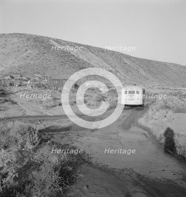 School bus starts up the flat 7:30 a.m. to collect children of new..., Malheur County, Oregon, 1939. Creator: Dorothea Lange.