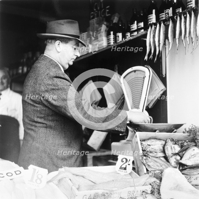 A weights and measures officer, London, (c1950-c1970?). Artist: Henry Grant