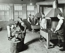 Boys using forges in a blacksmith's shop, Beaufoy Institute, London, 1911. Artist: Unknown.
