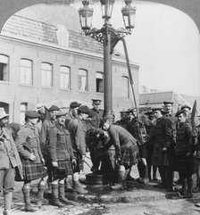 Soldiers filling their water bottles at the town pump La Gorgue, France, World War I, c1914-c1918. Artist: Realistic Travels Publishers