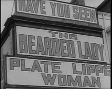 Signs at a Seaside Show 'HAVE YOU SEEN' 'THE BEARDED LADY' 'PLATE LIPPED WOMAN', 1938. Creator: British Pathe Ltd.