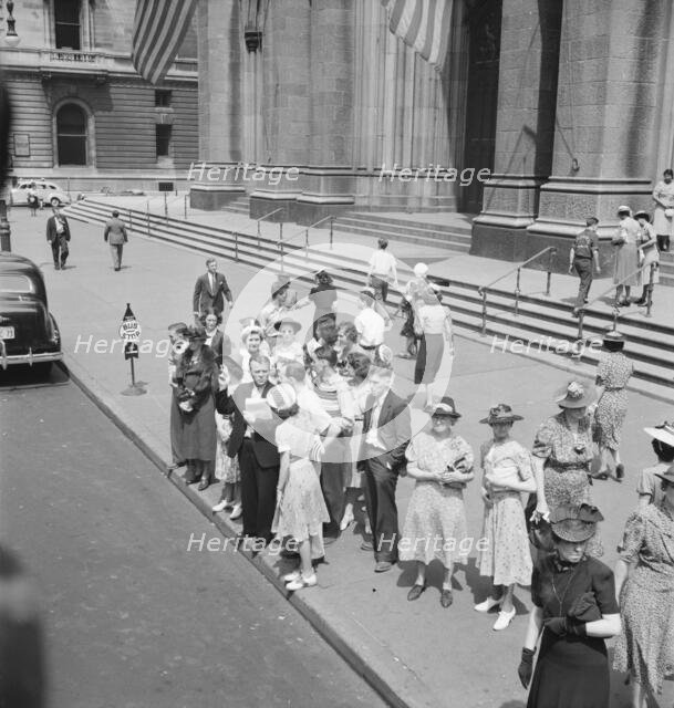 Fifth Avenue at Saint Patrick's Cathedral, waiting for an uptown bus, New York City, 1939. Creator: Dorothea Lange.