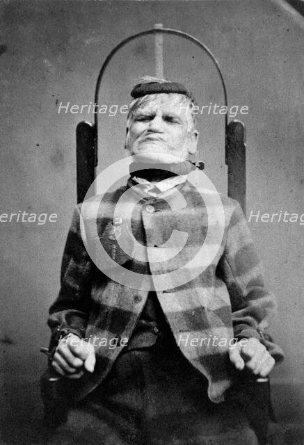 Wakefield Prison, Yorkshire: an elderly man, struggling against the restraint-chair in..., c1869. Creator: Unknown.