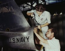 Mrs. Virginia Davis, a riveter in the assembly and repair department of the Naval air base..., 1942. Creator: Howard Hollem.
