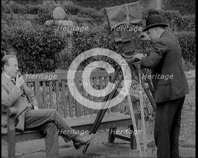 A Newsreel Camera Filming British Prime Minister Stanley Baldwin Sitting On a Bench in the..., 1924. Creator: British Pathe Ltd.