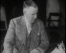 Charles B Cochran Sitting at a Table, 1920s. Creator: British Pathe Ltd.