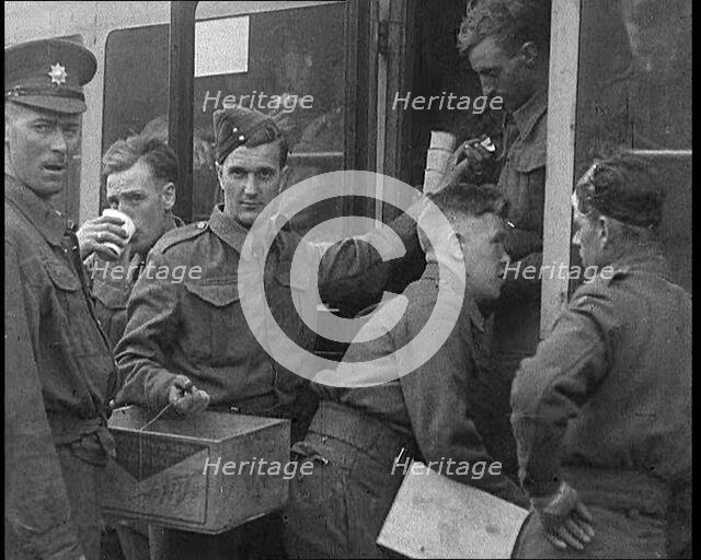 British Soldiers Receiving Food and Drinks on Trains Taking Them To Camp, 1940. Creator: British Pathe Ltd.