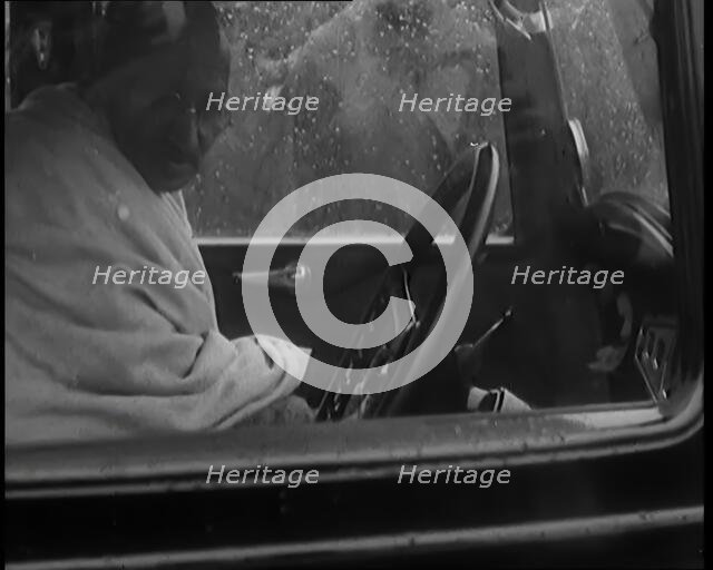 Mohandas K Gandhi (Mahatma) Sitting in a Car in the Rain, 1931. Creator: British Pathe Ltd.