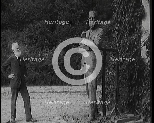 Playwright George Bernard Shaw Standing Next To a Statue of Himself, 1920s. Creator: British Pathe Ltd.