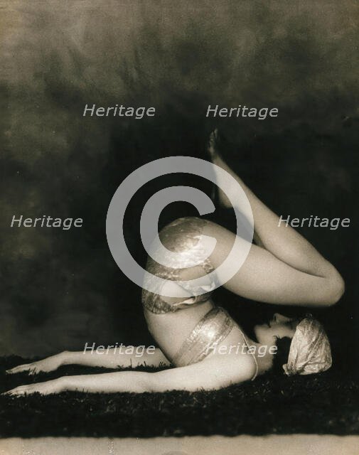 Marguerite Agniel posing with her back arched and feet in the air, wearing a two-piece cos..., 1929. Creator: Unknown.