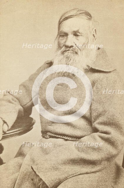 Three-quarter length portrait of an elderly convict, facing slightly left, between 1880 and 1886. Creator: Unknown.
