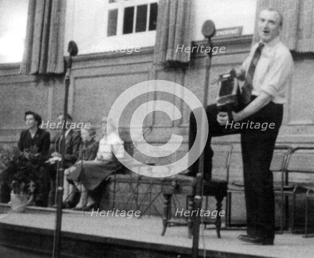 Bob Roberts playing the melodion, Cecil Sharp House, London, October 1957. Artist: Eddis Thomas