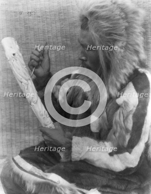 The ivory carver-Nunivak, c1929. Creator: Edward Sheriff Curtis.