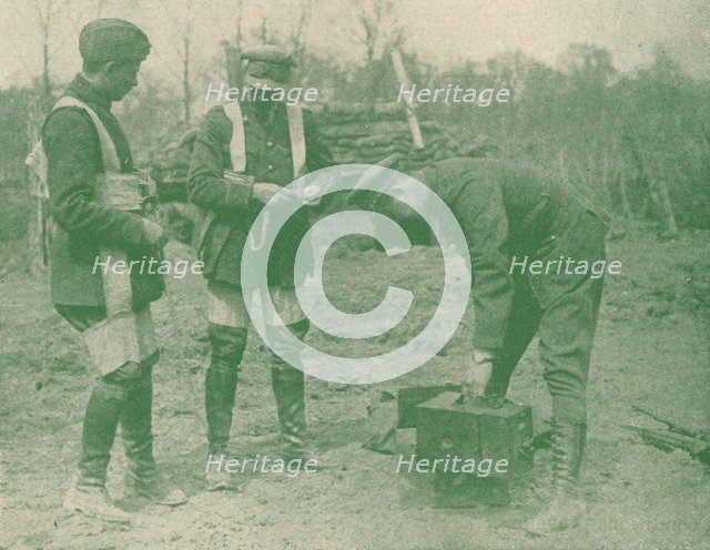 Aerial photographers fixing on parachute harnesses before making an ascent, c1917 (1919). Artist: Unknown.