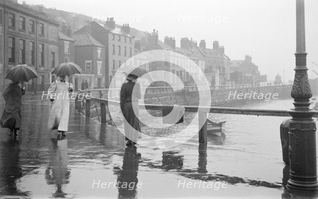 A rainy day on Pier Road, Whitby, North Yorkshire, 1896-1920. Artist: Alfred Newton & Sons.