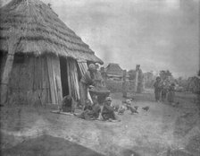 Ainu women and children outside a hut, 1908. Creator: Arnold Genthe.