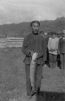 Shoria Man with Fish, Caught in the River Mrassu Rapid, 1913. Creator: GI Ivanov.
