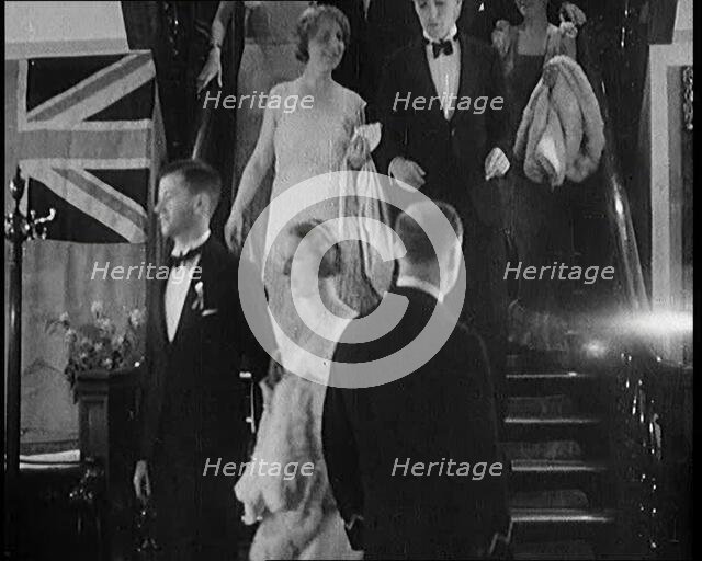 People in Evening Dress Walking Down Stairs, 1931. Creator: British Pathe Ltd.