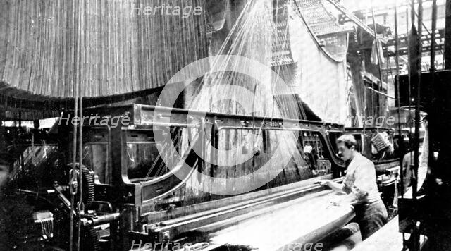 Weaving three-yard-wide quilts: a large jacquard loom in use, 1909. Creator: Unknown.