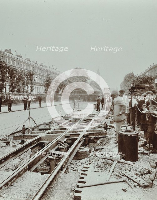 Workmen extending tramlines, Brixton Road, London, 1907. Artist: Unknown.
