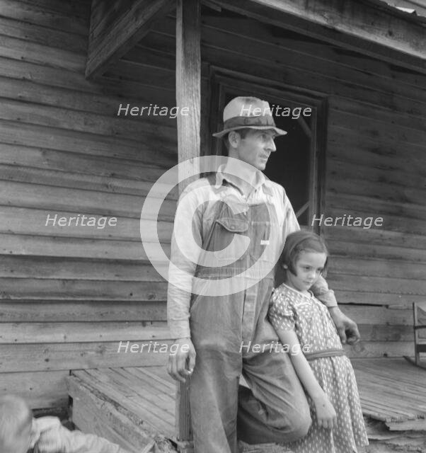Tobacco sharecropper with his oldest daughter, Person County, North Carolina, 1939. Creator: Dorothea Lange.