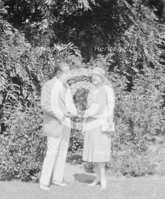 Alanson, Bertram, Mr. and Mrs., standing outdoors, between 1927 and 1937. Creator: Arnold Genthe.