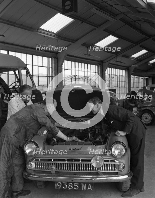 Automotive supplies representative with a 1960 Hillman Husky at a Sheffield Garage, 1963. Artist: Michael Walters