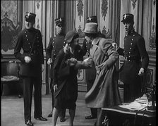 The Actor Gene Gerrard Hand Cuffed to His Co Star Being Watched By French Police They..., 1920s. Creator: British Pathe Ltd.