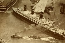 'An Aerial Photograph of the "Leviathan" Being Towed By Small Tugs Into Her Dock At New York', c1930 Creator: Unknown.